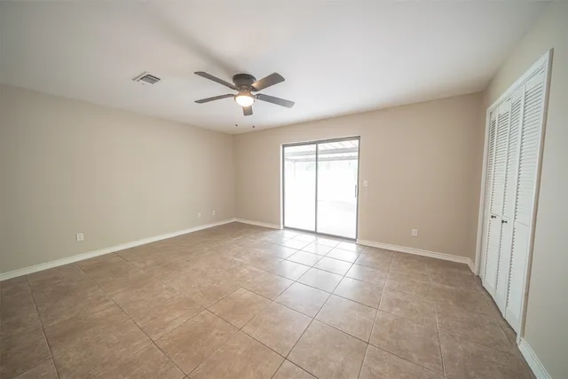 a view of an empty room with a ceiling fan