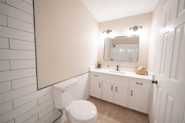 an empty room with a ceiling fan and a fan