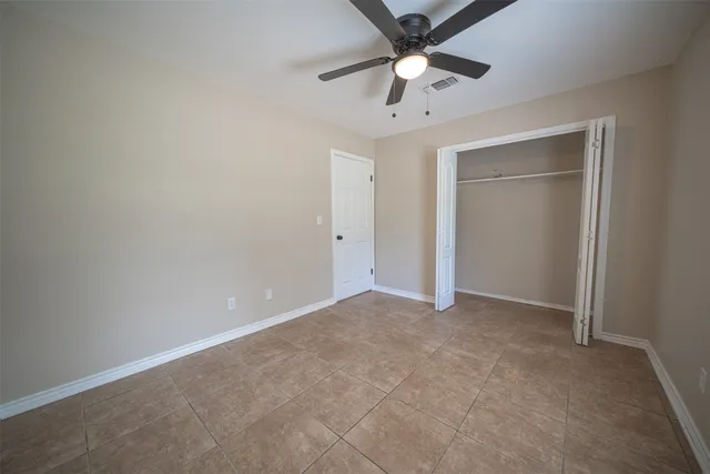 a bathroom with a toilet and a window