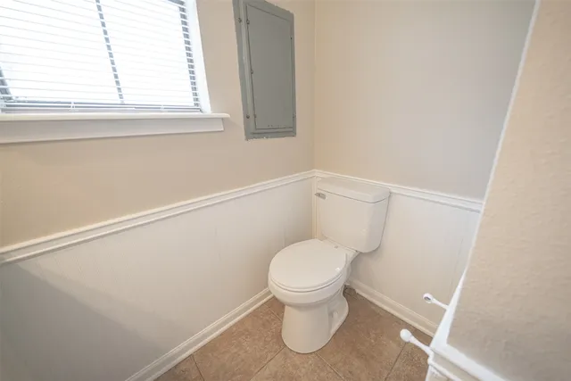 a kitchen with stainless steel appliances granite countertop a sink window and cabinets