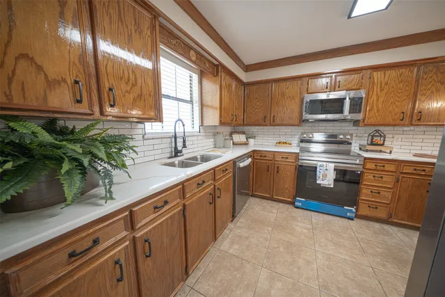 a kitchen with a sink stove top oven and cabinets