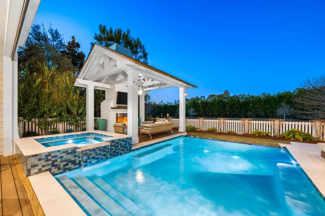 a view of a house with swimming pool and furniture