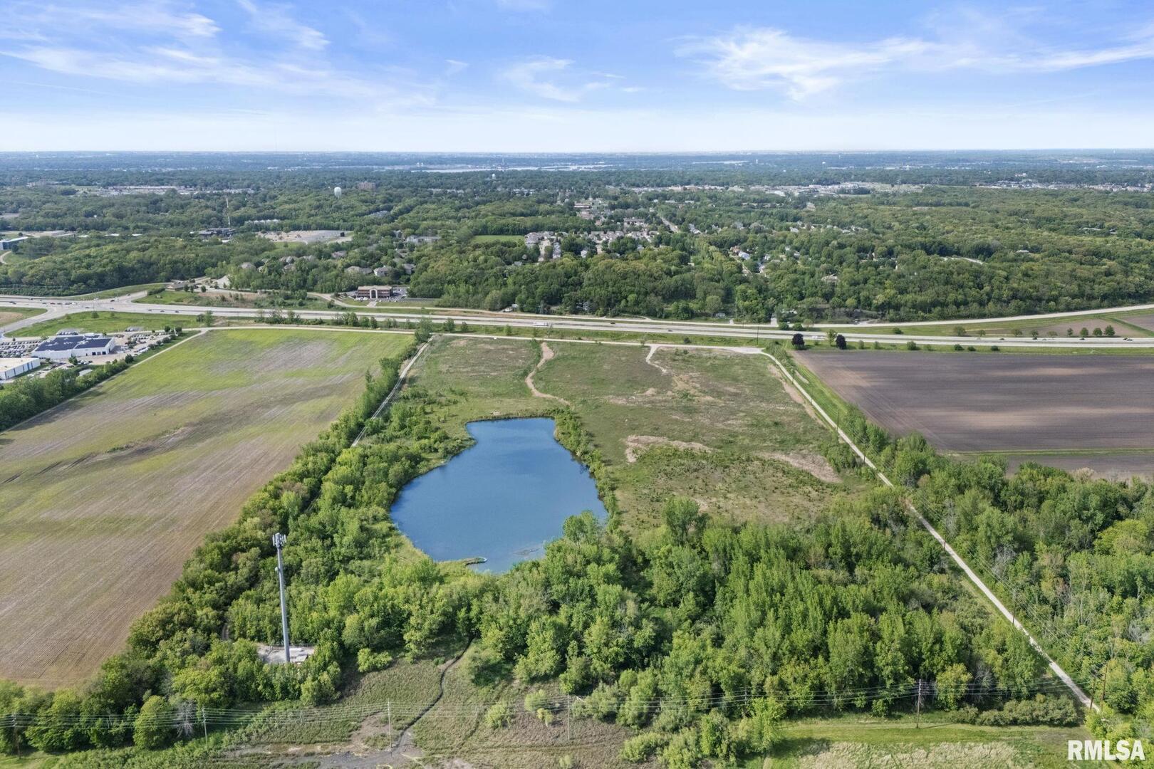 7300 John Deere Road Moline, IL 61265 - Photo 8 of 10 a view of a water pond with green yard