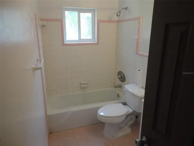 a bathroom with a toilet and a bathtub