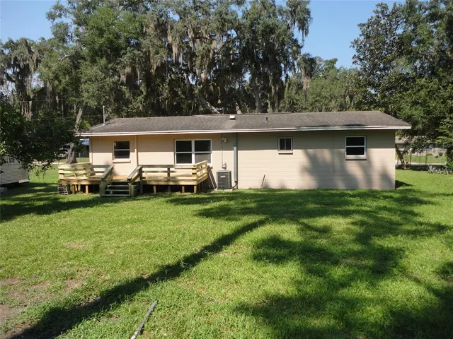 a front view of house with yard and trees