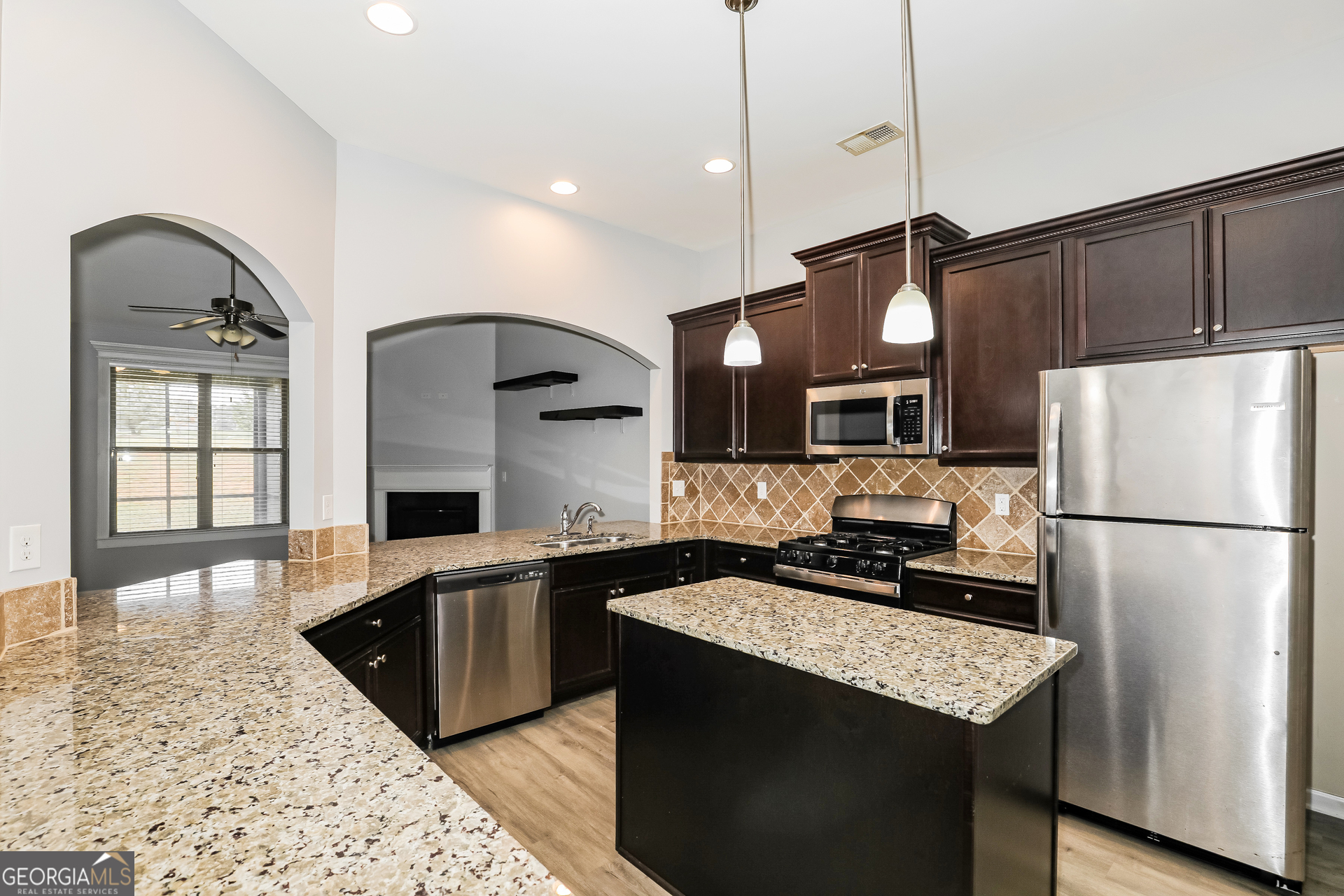 3216 Alhambra Circle Hampton, GA 30228 - Photo 8 of 21 a kitchen with stainless steel appliances granite countertop a sink a stove and refrigerator