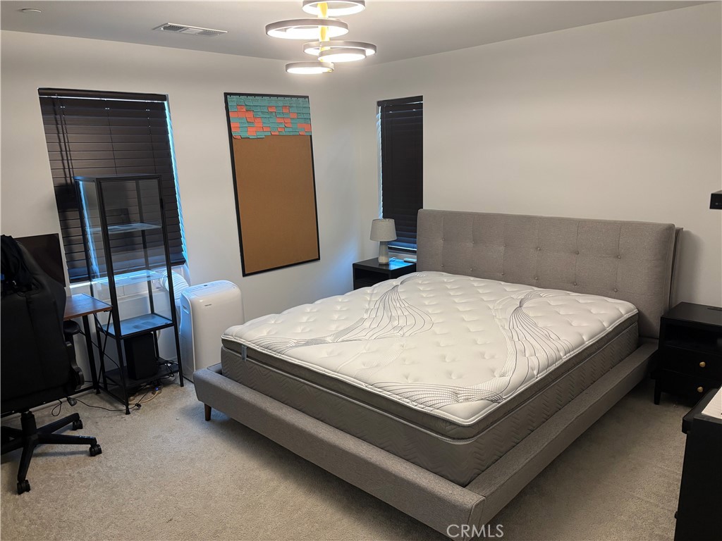 1375 Yeager Avenue Rialto, CA 92376 - Photo 11 of 12 a bed sitting in a room next to a window