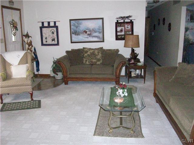 547 Turkey Ridge Road Mount Bethel, PA 18343 - Photo 5 of 14 a living room with furniture a table and a painting on the wall