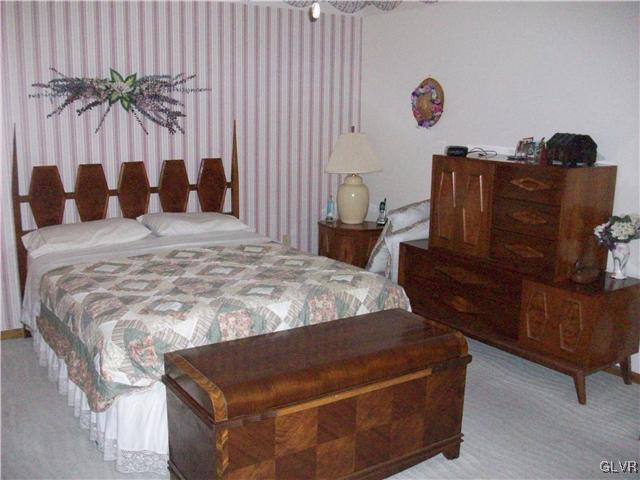547 Turkey Ridge Road Mount Bethel, PA 18343 - Photo 9 of 14 a bed sitting in a bedroom next to a window