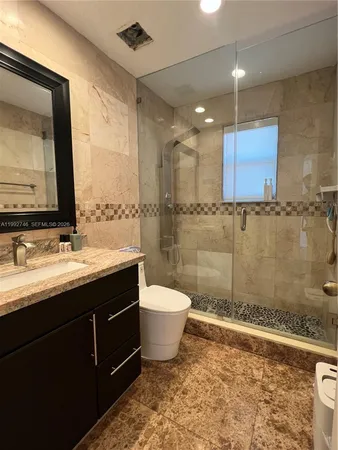 a bathroom with a double vanity sink a mirror and a bathtub