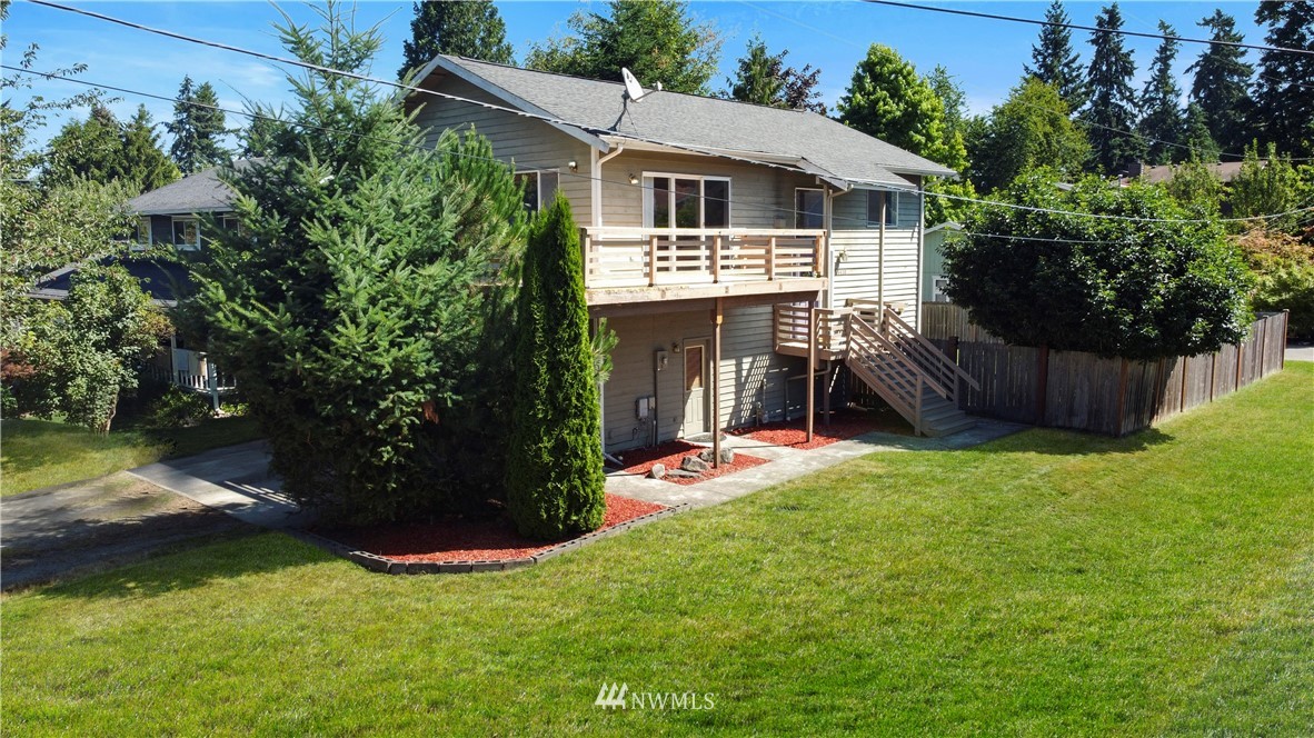 26410 218th Avenue Southeast Maple Valley, WA 98038 - Photo 2 of 28 a front view of a house with yard and green space