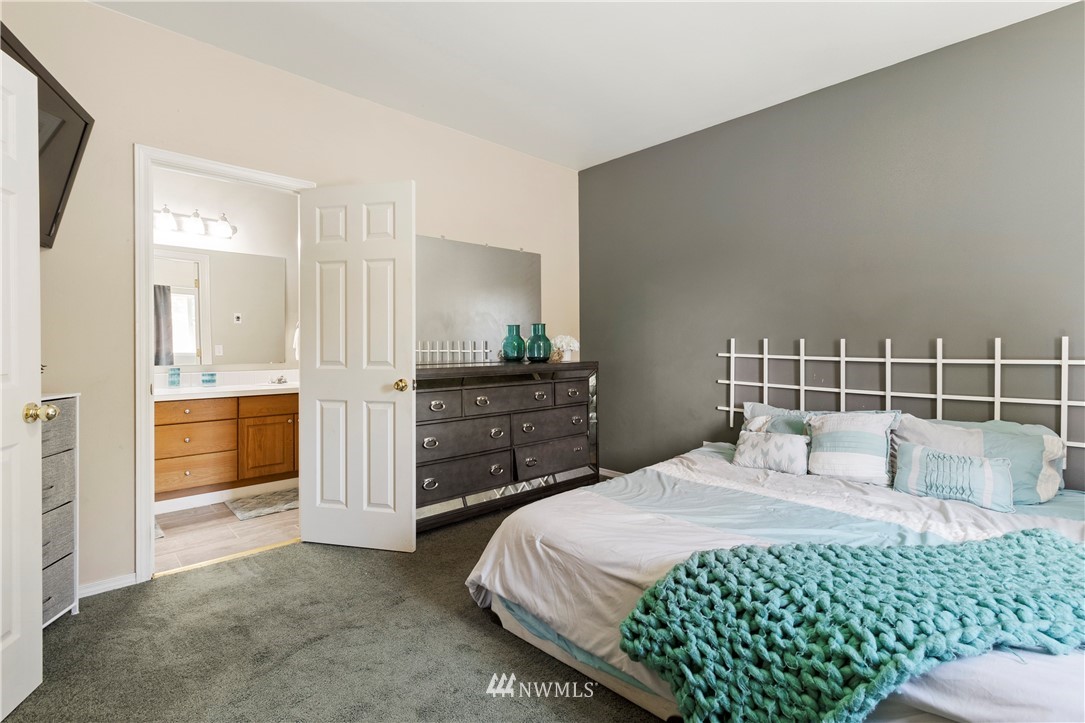 26410 218th Avenue Southeast Maple Valley, WA 98038 - Photo 12 of 28 a bedroom with a large bed and a dresser