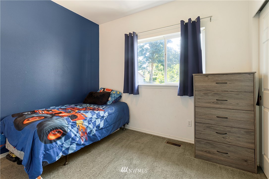 26410 218th Avenue Southeast Maple Valley, WA 98038 - Photo 14 of 28 a bedroom with a bed and a window