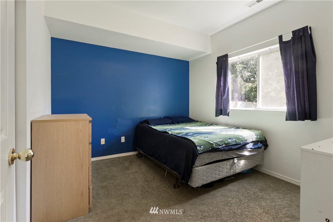 26410 218th Avenue Southeast Maple Valley, WA 98038 - Photo 17 of 28 a bedroom with a bed dresser and a window