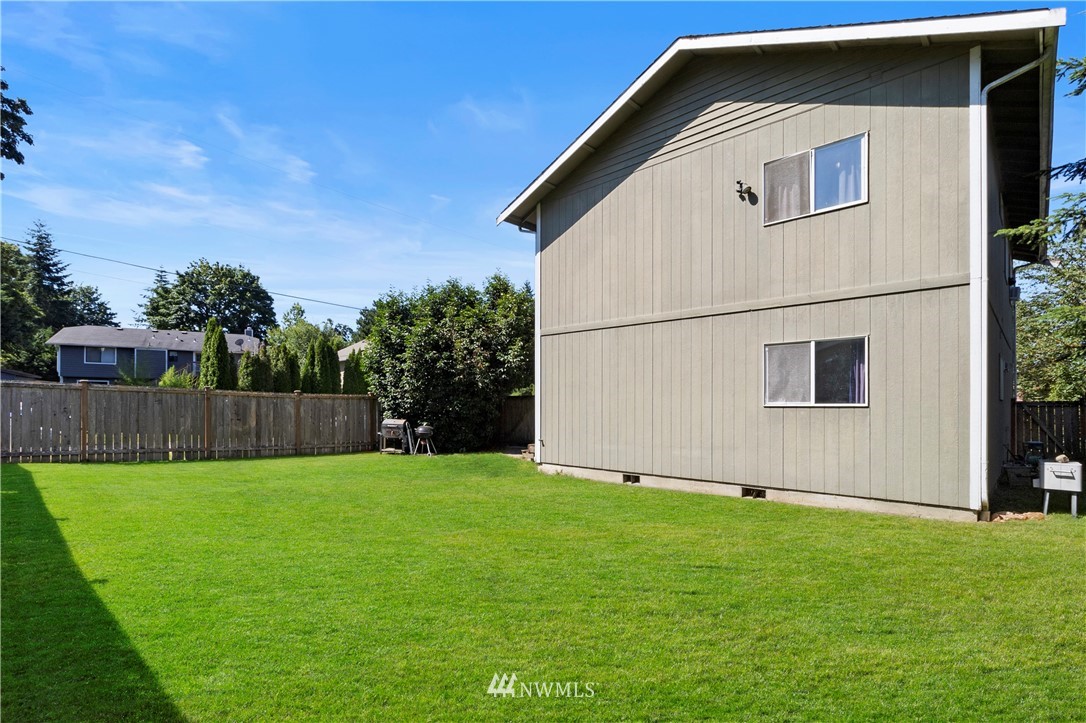 26410 218th Avenue Southeast Maple Valley, WA 98038 - Photo 23 of 28 a view of backyard with potted plants and wooden fence