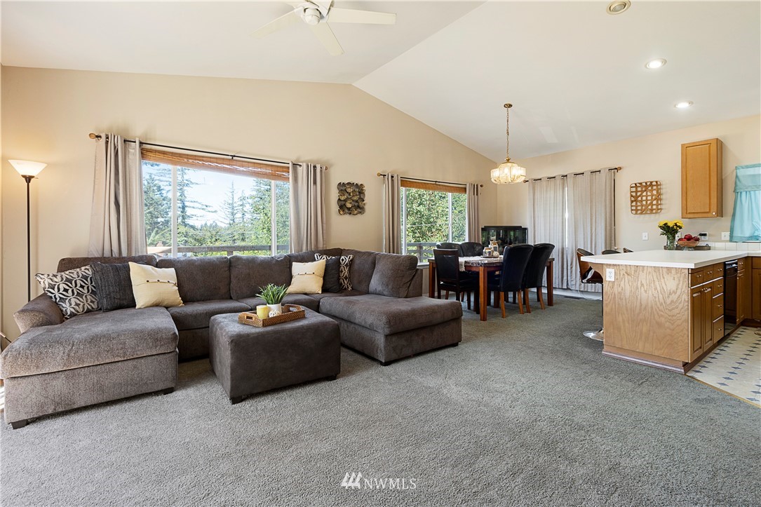26410 218th Avenue Southeast Maple Valley, WA 98038 - Photo 5 of 28 a living room with furniture and kitchen view