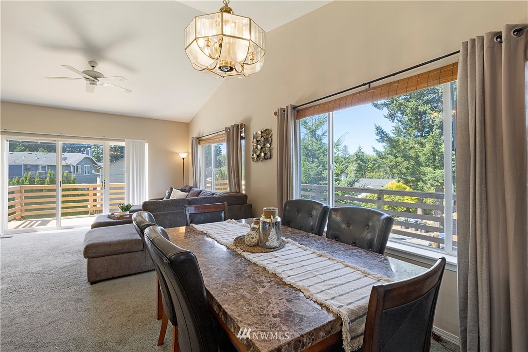 26410 218th Avenue Southeast Maple Valley, WA 98038 - Photo 10 of 28 a view of a dining room with furniture wooden floor and chandelier