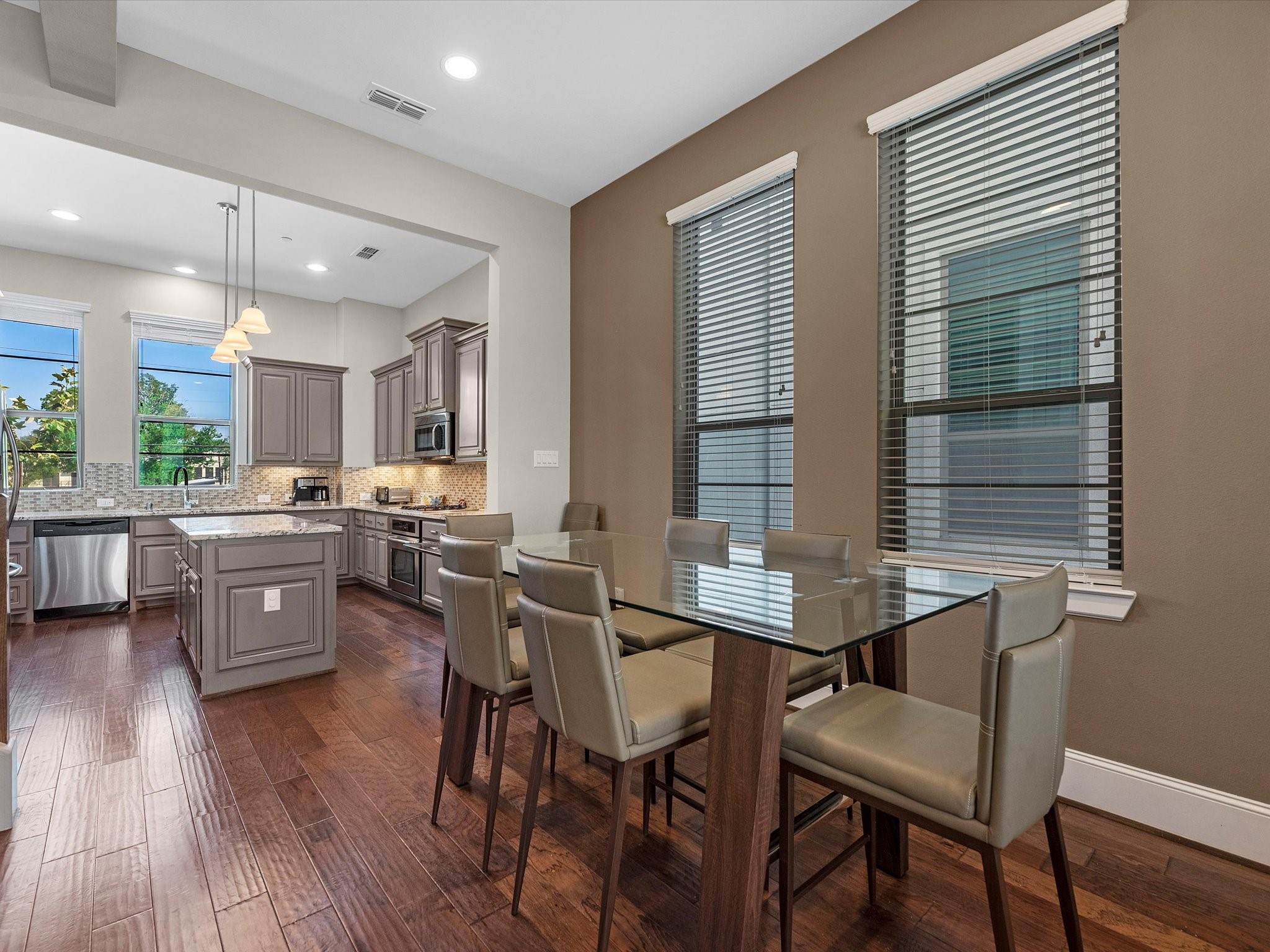 5467 Larkin Street Houston, TX 77007 - Photo 7 of 33 a kitchen with a table chairs a sink dishwasher window and cabinets