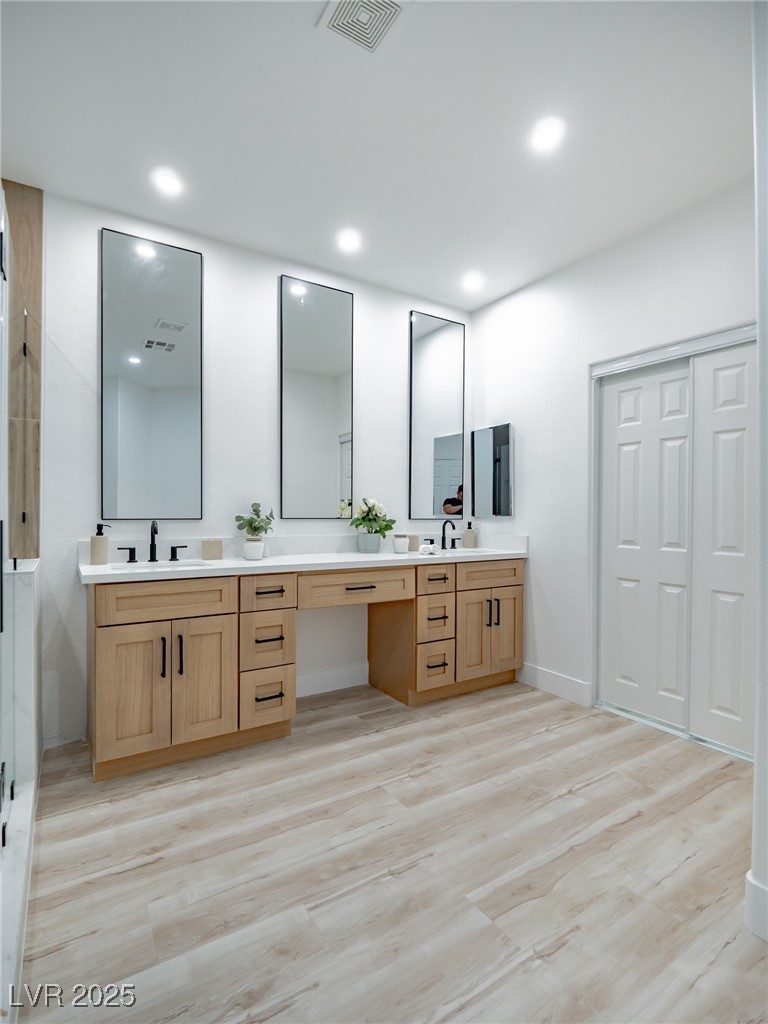 7870 Midnight Ride Street Las Vegas, NV 89131 - Photo 48 of 69 Full bath with double vanity, light wood-style flooring, recessed lighting, and a shower