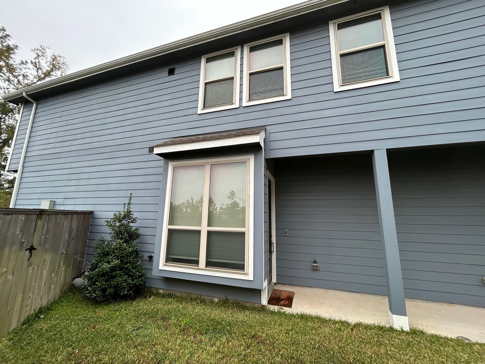 975 Lars Trek Trail Conroe, TX 77304 - Photo 14 of 36 a view of a house with a yard and wooden fence