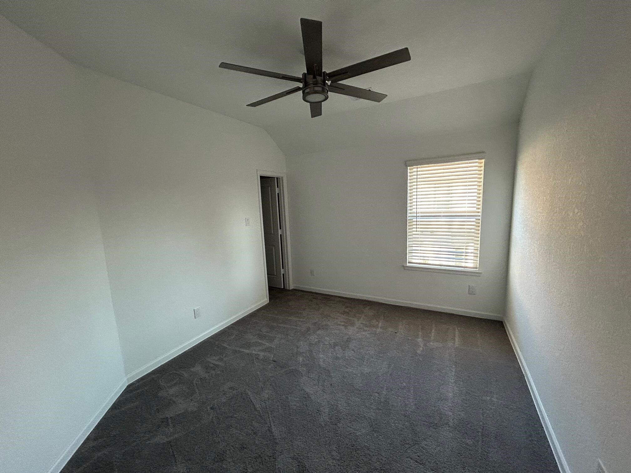 975 Lars Trek Trail Conroe, TX 77304 - Photo 17 of 36 an empty room with a window and a fan