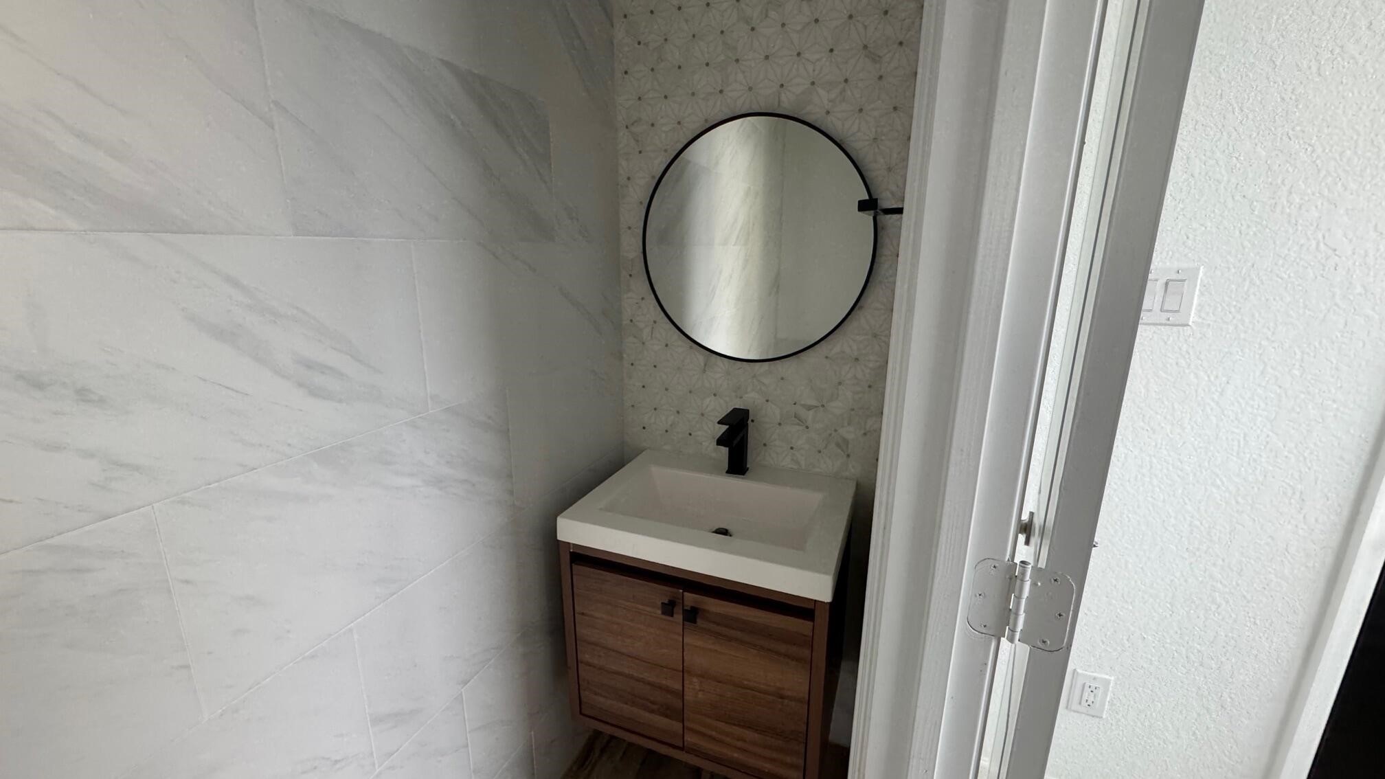 975 Lars Trek Trail Conroe, TX 77304 - Photo 24 of 36 a bathroom with a sink and a mirror