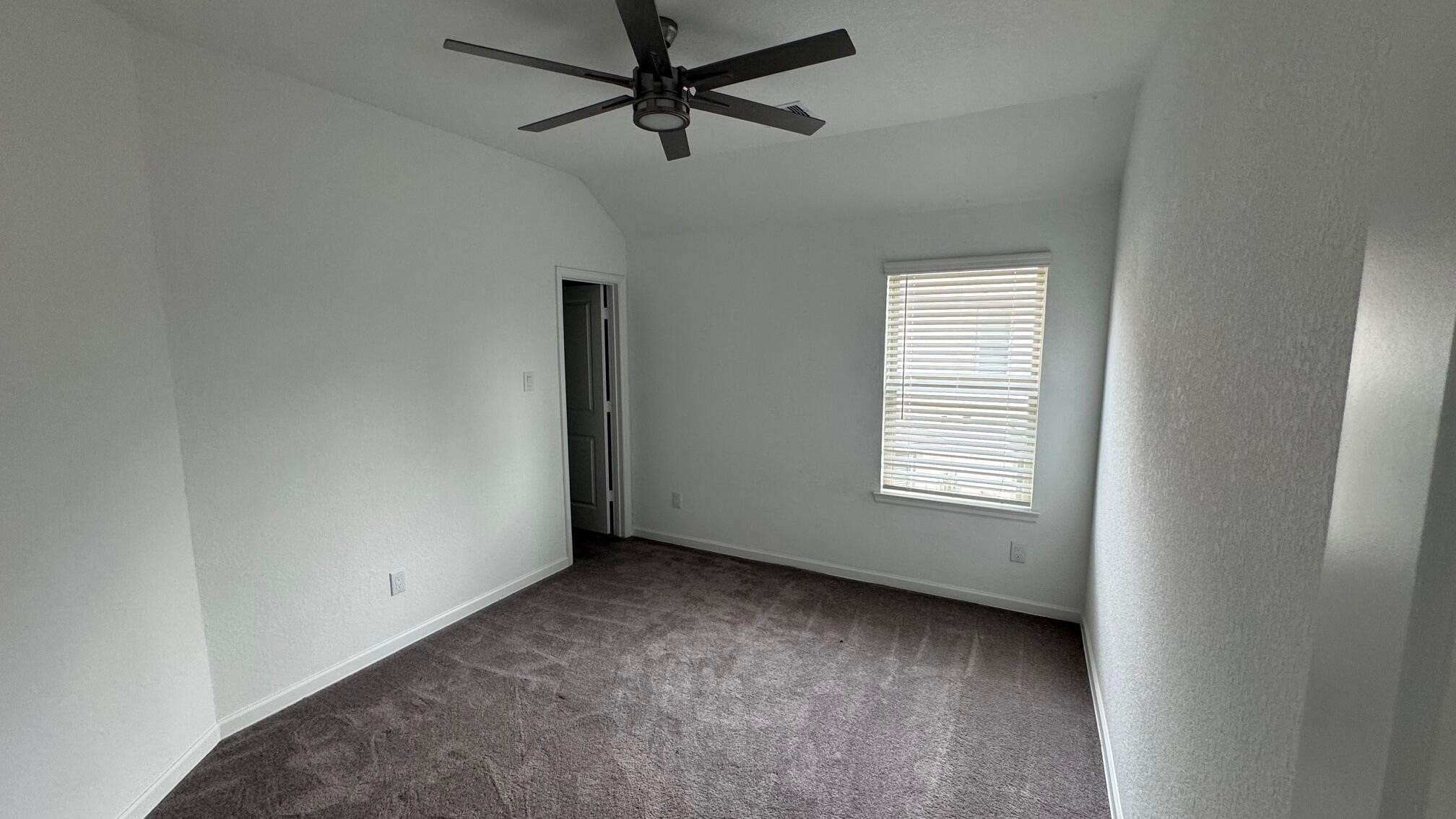 975 Lars Trek Trail Conroe, TX 77304 - Photo 28 of 36 a view of room with a ceiling fan and window