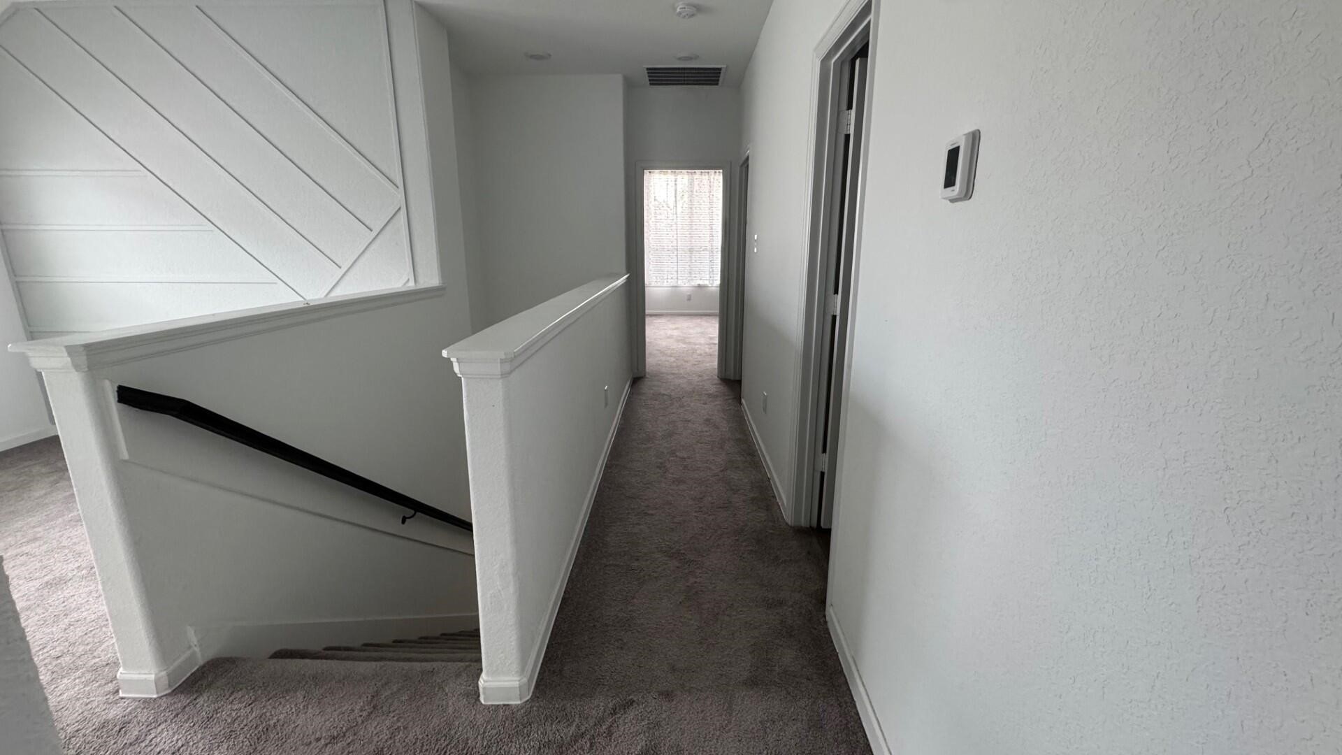 975 Lars Trek Trail Conroe, TX 77304 - Photo 29 of 36 a view of a hallway with wooden floor and stairs
