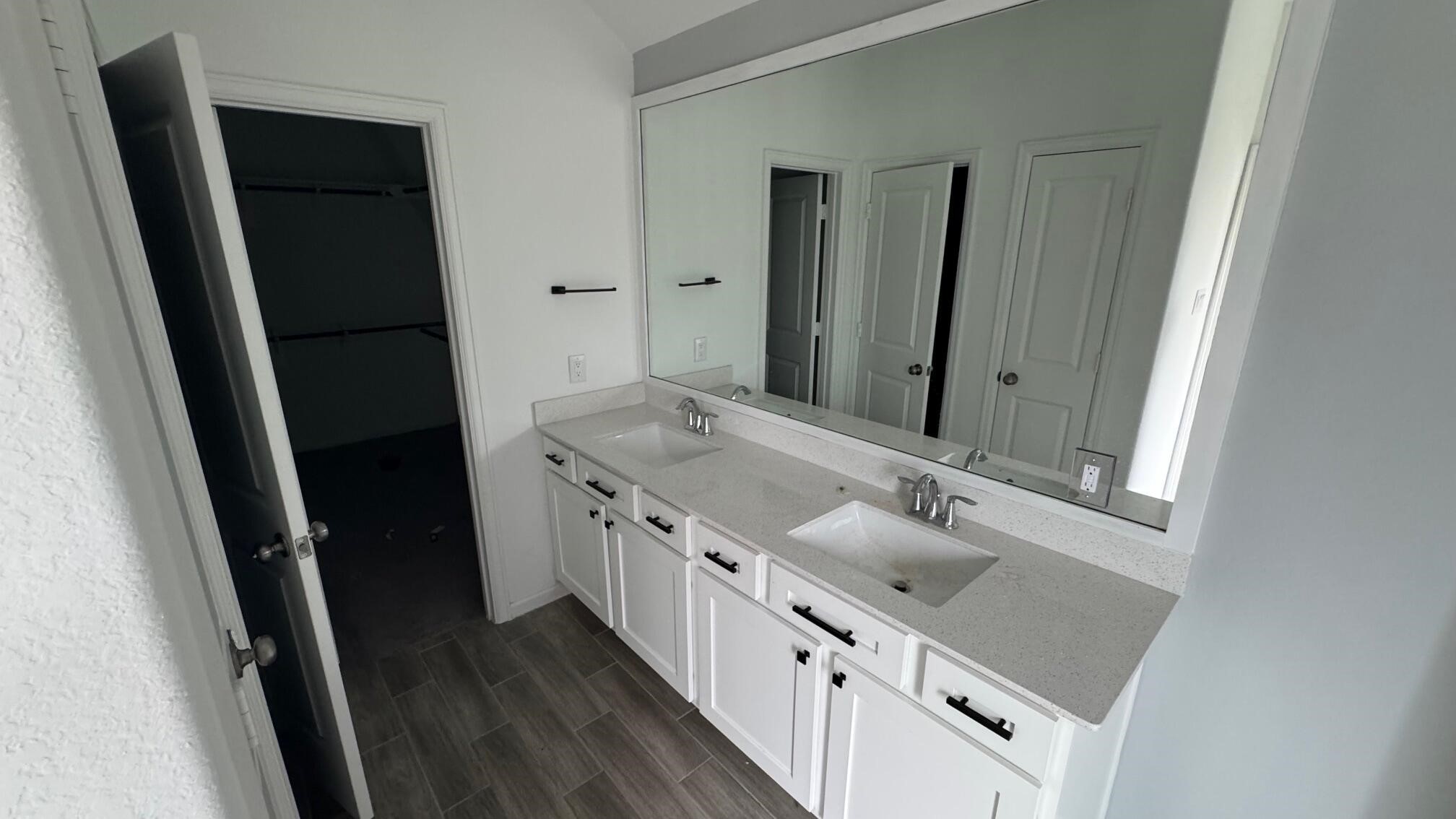 975 Lars Trek Trail Conroe, TX 77304 - Photo 30 of 36 a bathroom with a double vanity sink and mirror