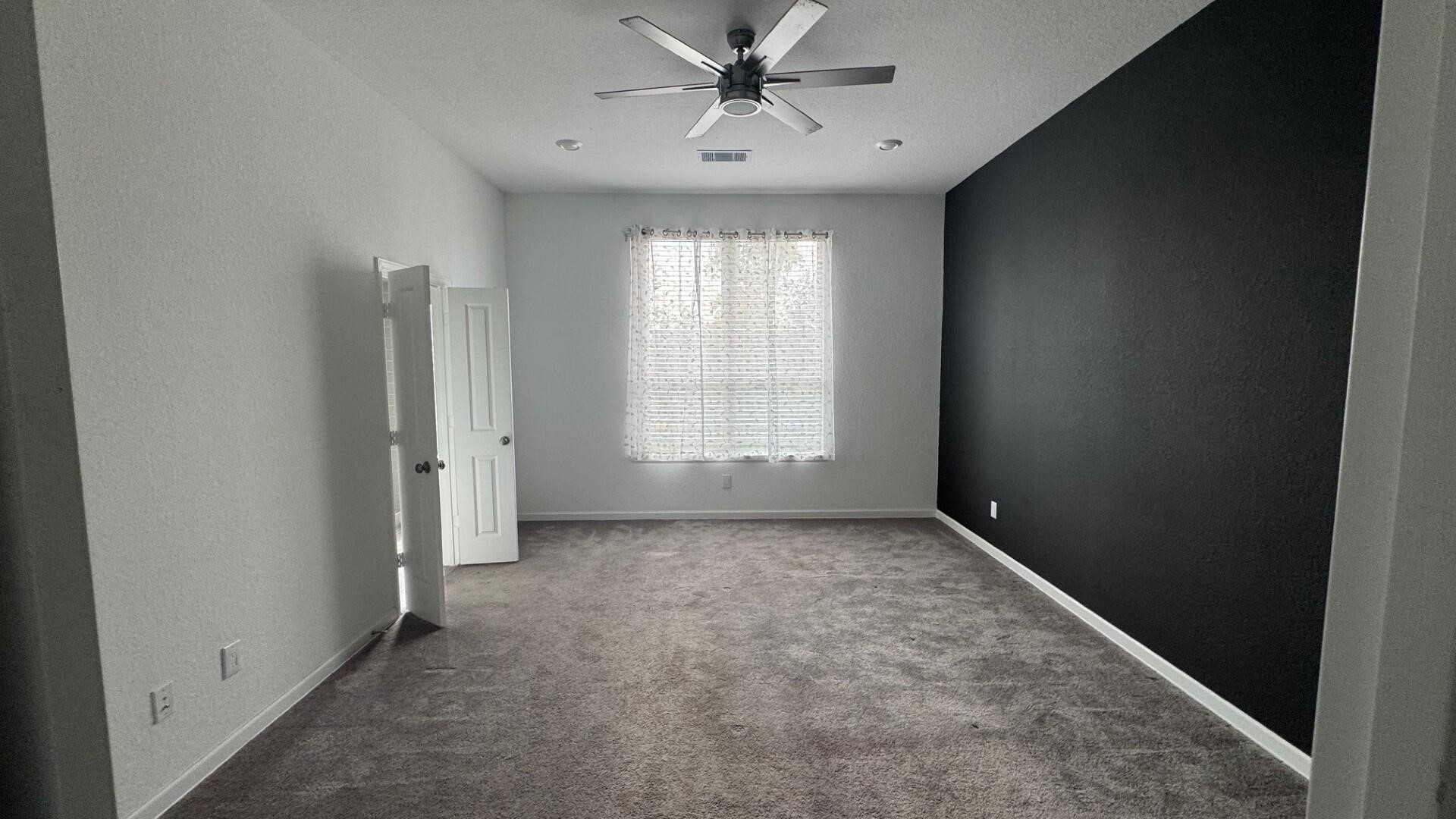 975 Lars Trek Trail Conroe, TX 77304 - Photo 33 of 36 an empty room with windows and fan