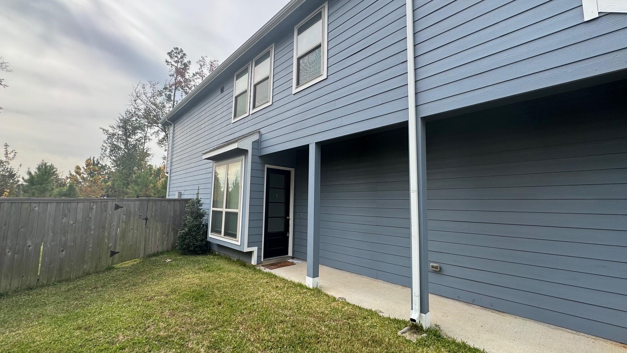 975 Lars Trek Trail Conroe, TX 77304 - Photo 4 of 36 a backyard of a house