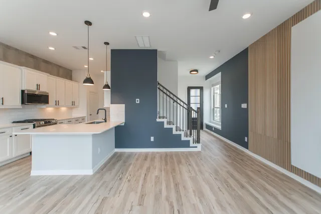 a view of a hallway with wooden floor and a fireplace