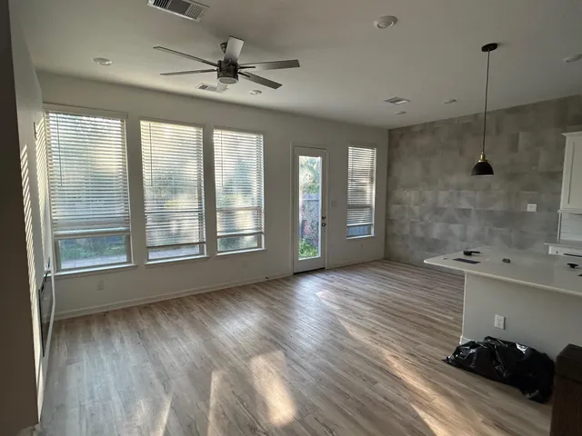 a kitchen with granite countertop a sink a stove and refrigerator