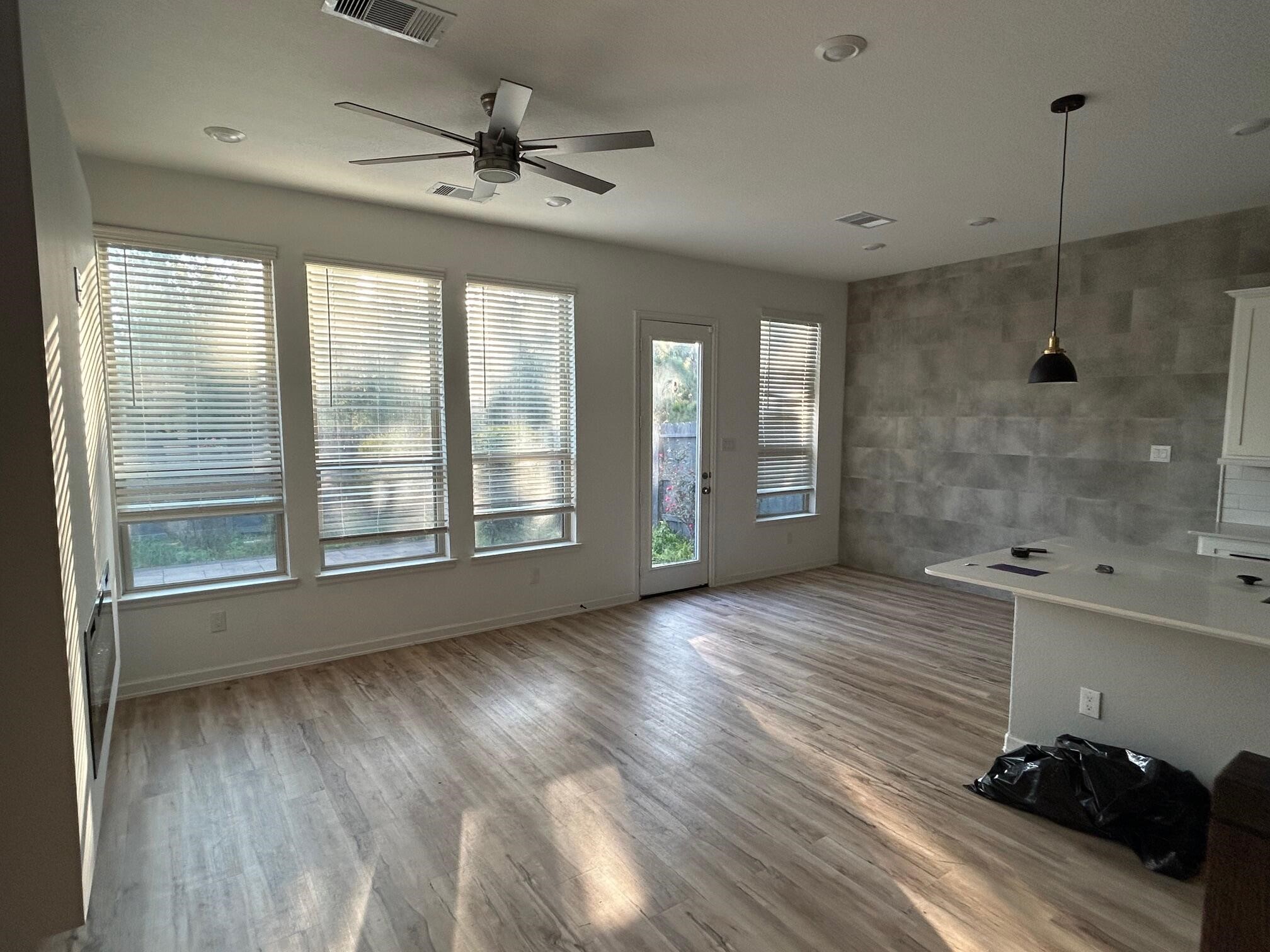 975 Lars Trek Trail Conroe, TX 77304 - Photo 8 of 36 a view of an empty room with a window and wooden floor