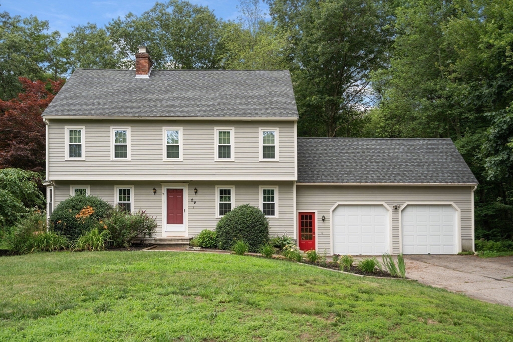 a front view of a house with a garden and plants