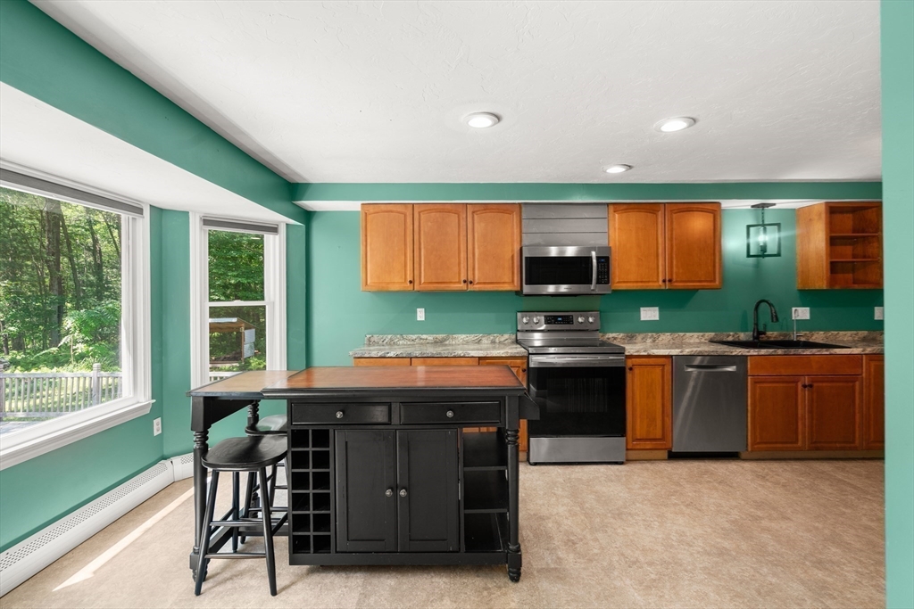 29 Chipper Hill Road Northbridge, MA 01534 - Photo 13 of 36 a kitchen with a stove a sink and a refrigerator