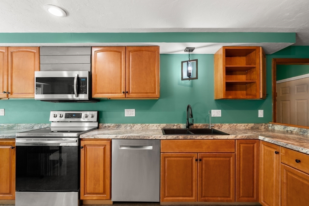 29 Chipper Hill Road Northbridge, MA 01534 - Photo 14 of 36 a kitchen with stainless steel appliances granite countertop a sink and a microwave