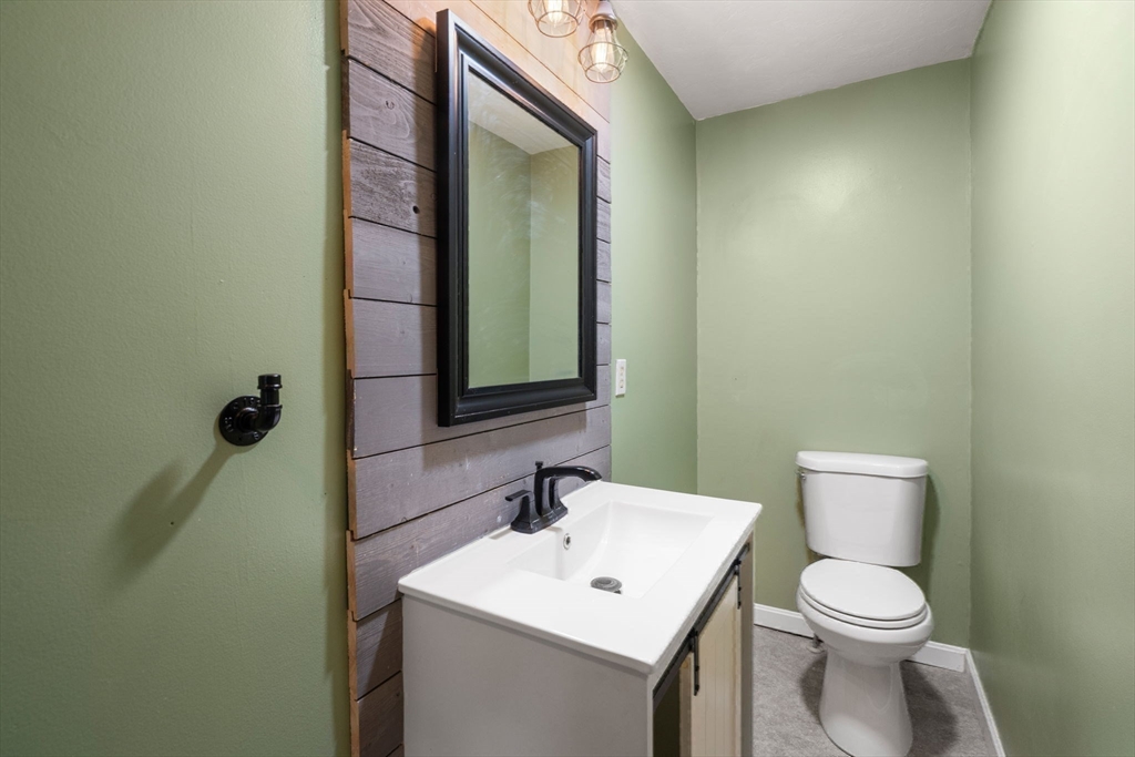 29 Chipper Hill Road Northbridge, MA 01534 - Photo 17 of 36 a bathroom with a toilet a sink and mirror