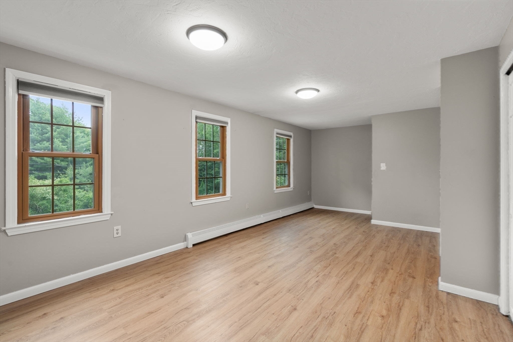 29 Chipper Hill Road Northbridge, MA 01534 - Photo 22 of 36 a view of an empty room with wooden floor and a window