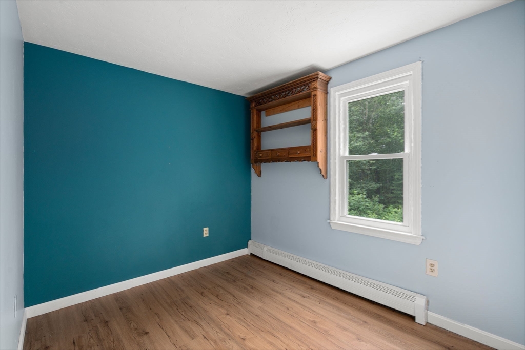 29 Chipper Hill Road Northbridge, MA 01534 - Photo 27 of 36 an empty room with wooden floor and windows