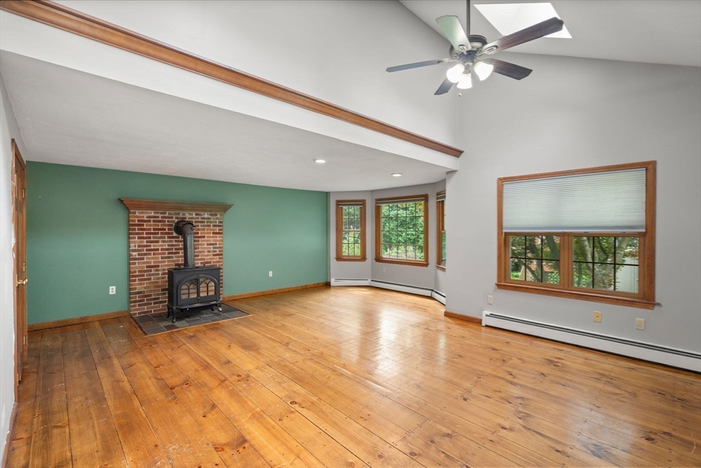 29 Chipper Hill Road Northbridge, MA 01534 - Photo 3 of 36 a view of an empty room with window and wooden floor