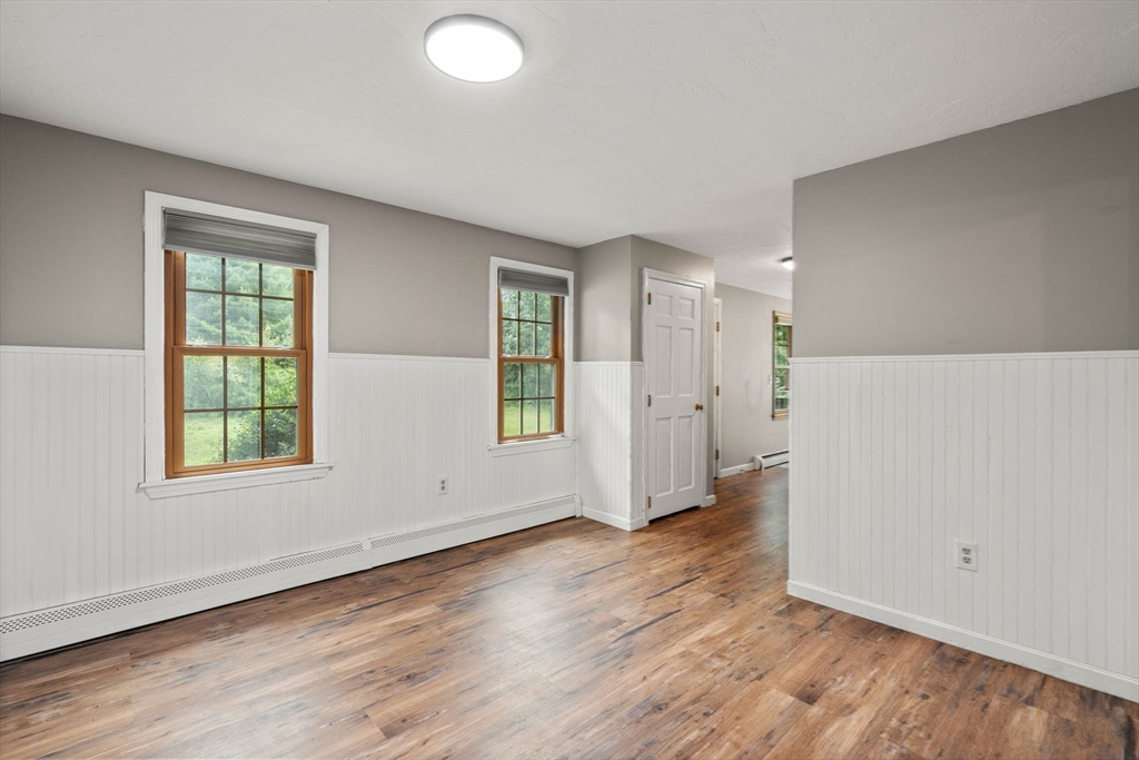 29 Chipper Hill Road Northbridge, MA 01534 - Photo 7 of 36 an empty room with wooden floor and windows