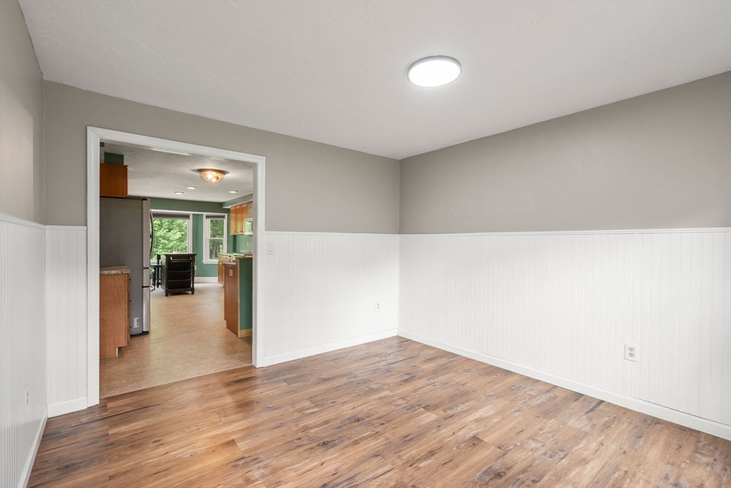 29 Chipper Hill Road Northbridge, MA 01534 - Photo 8 of 36 a view of a livingroom with wooden floor and a ceiling fan