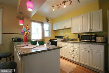 2018 Jasmine Road Baltimore, MD 21222 - Photo 4 of 6 a kitchen with granite countertop a sink a stove and cabinets