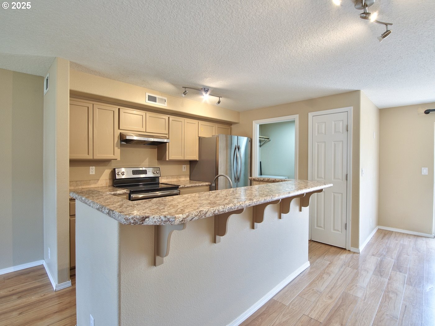 3229 North Meridian Street Newberg, OR 97132 - Photo 12 of 41 a large kitchen with stainless steel appliances granite countertop a stove a sink and a refrigerator