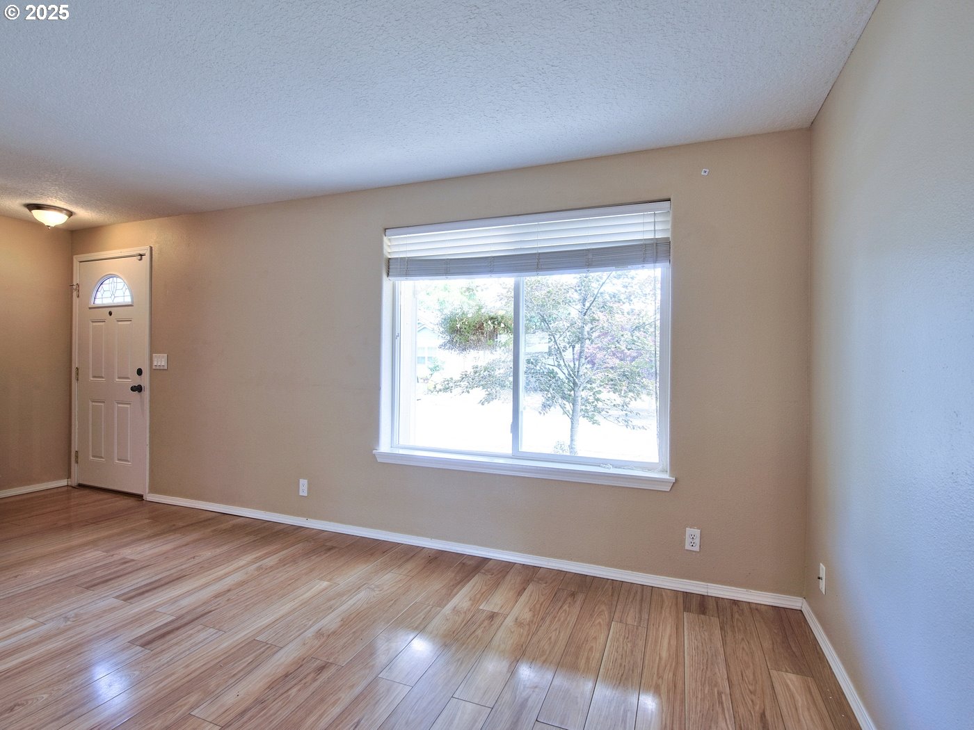 3229 North Meridian Street Newberg, OR 97132 - Photo 7 of 41 a view of an empty room with wooden floor and a window