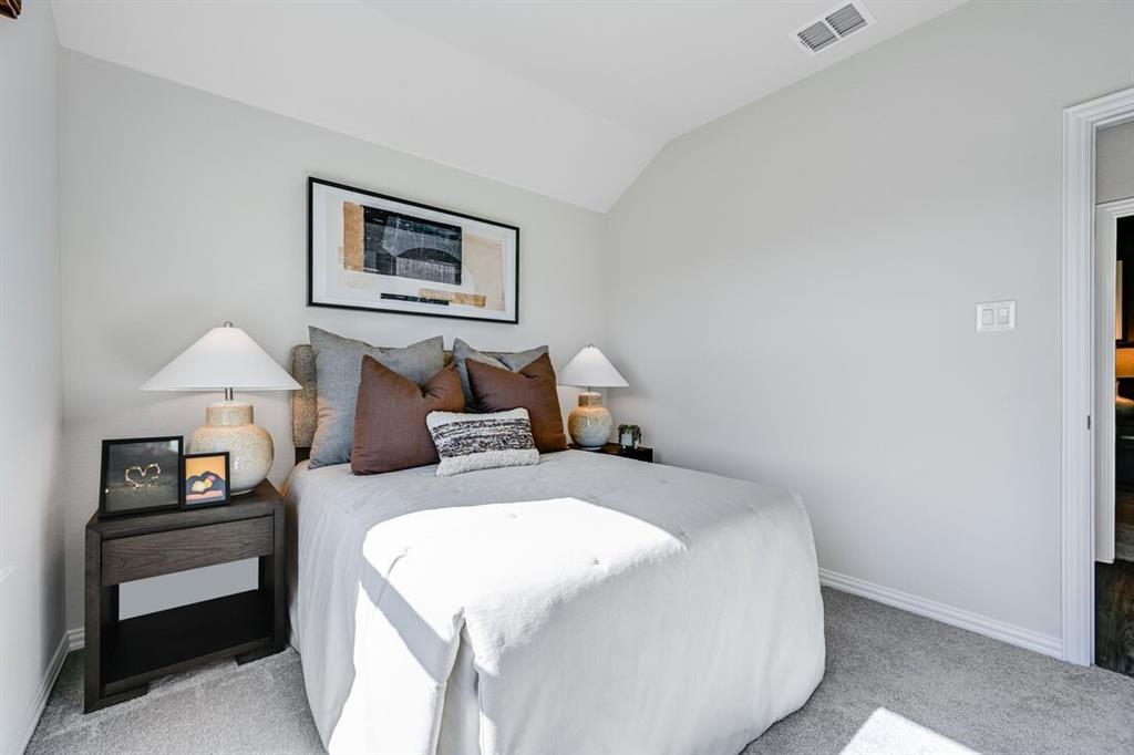 2621 Glacier Road Anna, TX 75409 - Photo 10 of 38 a bedroom with a bed and a lamp on table