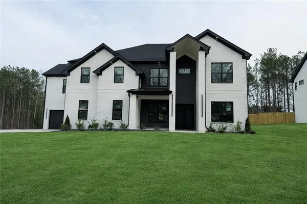 a front view of a house with a yard
