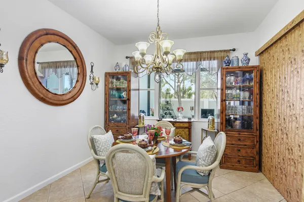 a dining room with furniture a chandelier and a rug