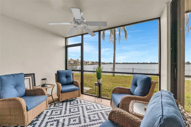 a living room with furniture and a floor to ceiling window